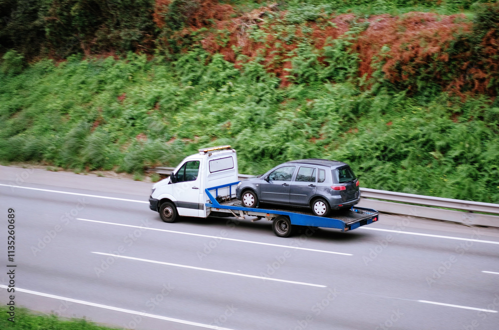 Tow Truck Transporting Minivan On Flatbed for Roadside Assistance Tow Truck Transporting Minivan On Flatbed for Roadside Assistance