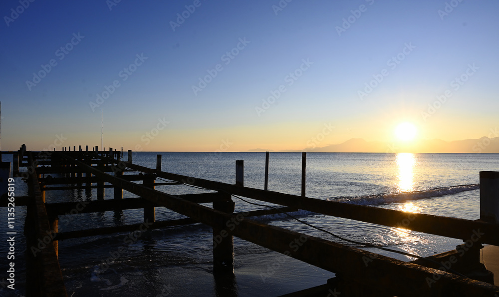Obraz premium old and disused iron pier extending towards the sea