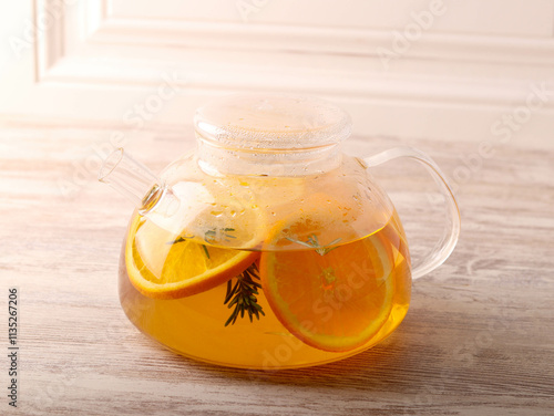 Hot infused drink with orange and rosemary photo