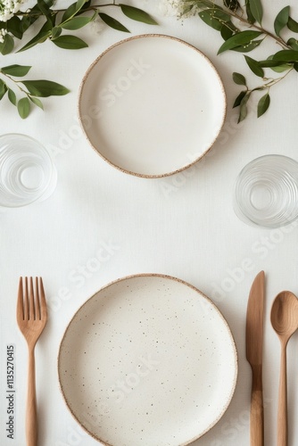 Elegant table setting with simple plates and natural decor for a casual dinin...