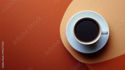 Coffee cup with rich foam on a warm brown background creating a cozy atmosphere