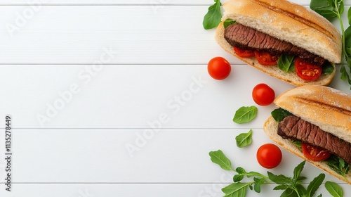 Delicious steak sandwiches with fresh vegetables and herbs served on a white ...