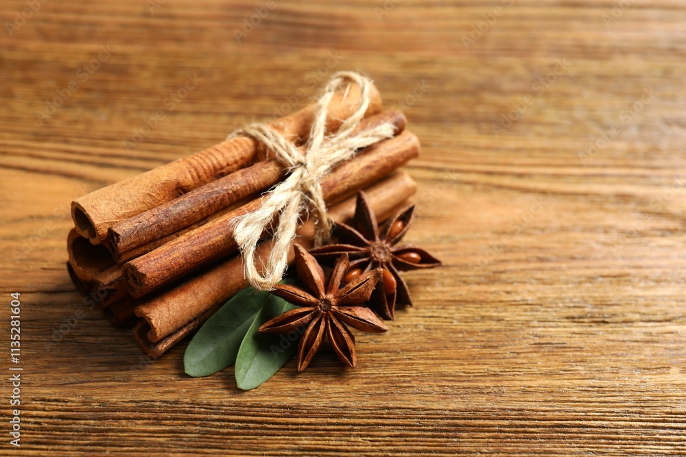 Aromatic cinnamon and anise stars on a wooden background Aromatic cinnamon and anise stars on a wooden background