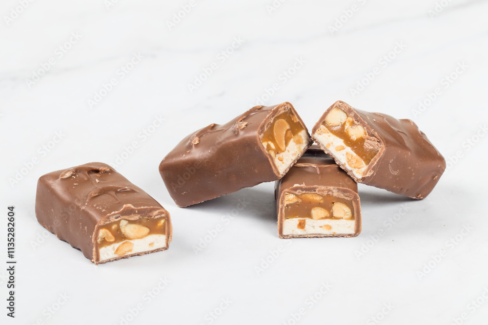 Candy bar. Nougat, caramel with peanuts, in chocolate. Close-up Candy bar. Nougat, caramel with peanuts, in chocolate. Close-up