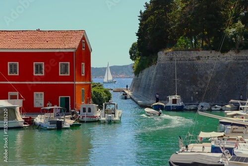 Fototapeta Naklejka Na Ścianę i Meble -  harbor with boats. sailboat in the distance
