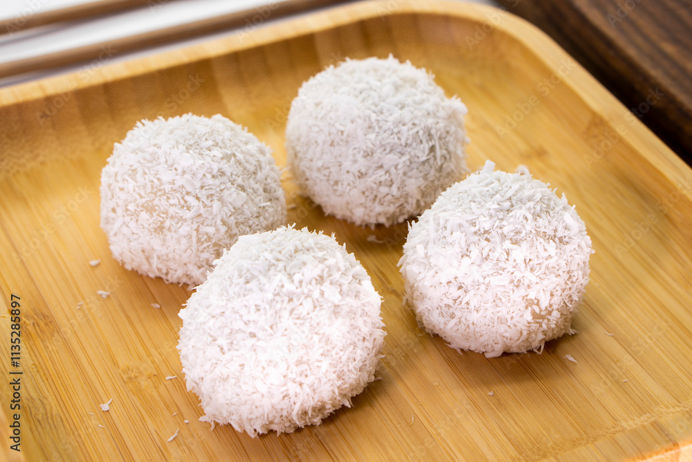 Japanese dessert mochi with red bean filling and coconut flakes. chopsticks. food concept. Japanese dessert mochi with red bean filling and coconut flakes. chopsticks. food concept.