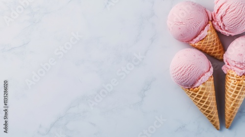 Delicious pink ice cream cones arranged on a light marble surface ready to be...