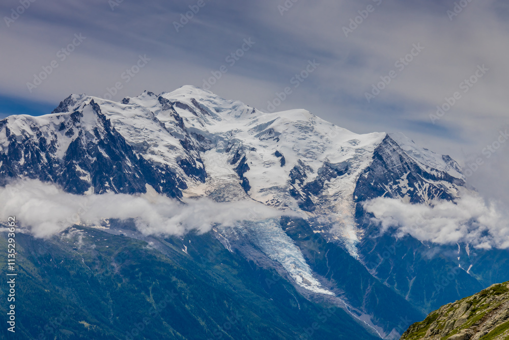 Fototapeta premium Mont Blanc, Monte Bianco mountain summit in the Alps. The highest mountain in Europe. Snow and glacier covered high altitude snow mountain in the Alps. The top of Montblanc Chamonix valley landscape