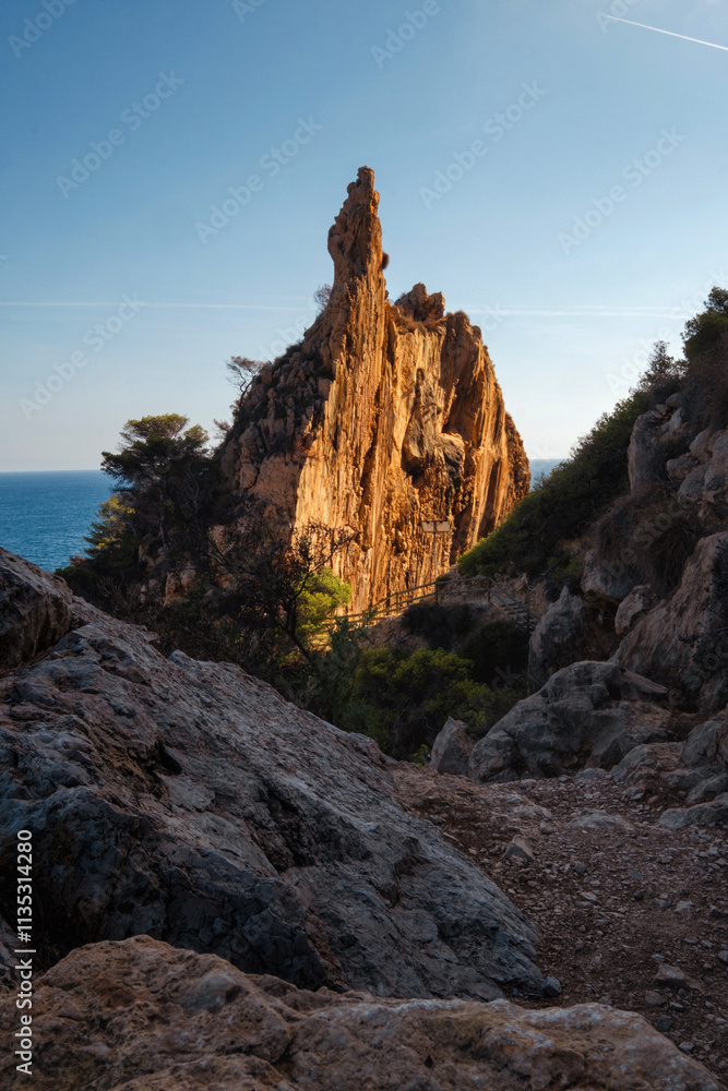 a landscape of a stone cliff in the warm sunset a landscape of a stone cliff in the warm sunset