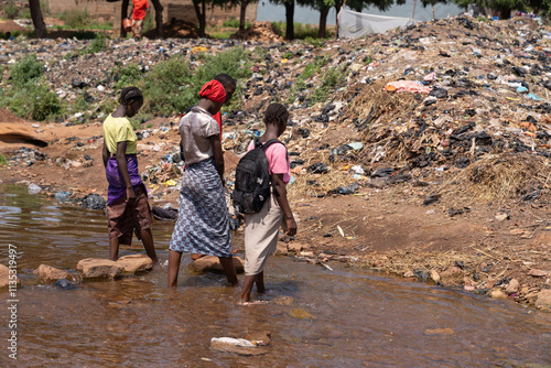 Photography Desolate image of a group of African village children living amidst mountains of