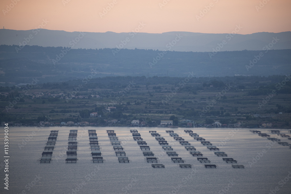 Fototapeta premium Breathtaking Sunset Over Ocean Aquaculture Platforms Enhancing Marine Ecology and Sustainability