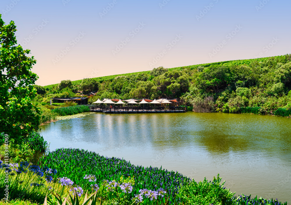 Fototapeta premium Lakeside restaurant with deck seating in Somerset West, South Africa