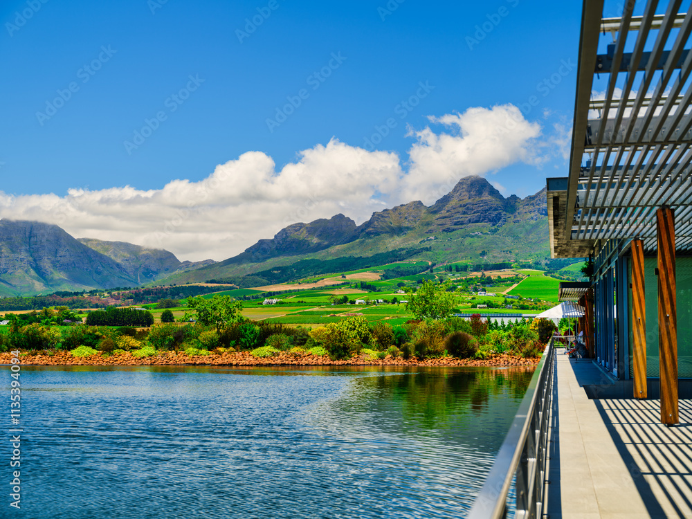 Balcony overlooking a dam with Helderberg Mountain and vineyards on the slope, Somerset West, South Africa