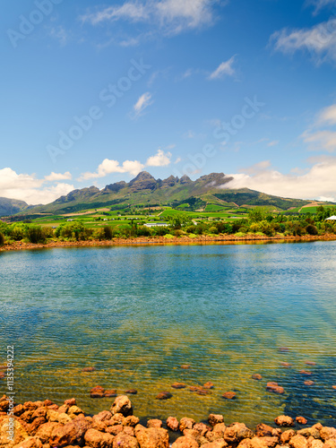 Obraz na płótnie Vertical view of Helderberg Mountain with vineyards on the slopes and a crystal-clear water dam, Somerset West, South Africa w salonie