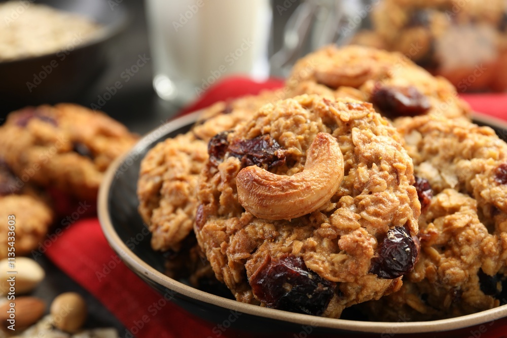 Delicious oatmeal cookies with raisins and nuts on table, closeup Delicious oatmeal cookies with raisins and nuts on table, closeup