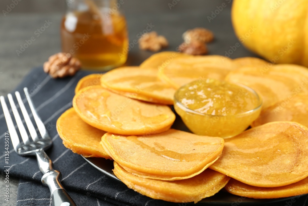 Tasty pumpkin pancakes with honey and jam on table, closeup Tasty pumpkin pancakes with honey and jam on table, closeup