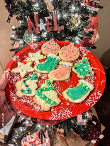 A plate of festive and colorful frosted Christmas cookies