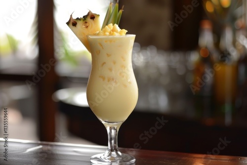 Refreshing Tropical Cocktail in Elegant Glass with Pineapple Garnish Set Against a Blurry Bar Background, Perfect for Summer Themes and Tropical Parties photo