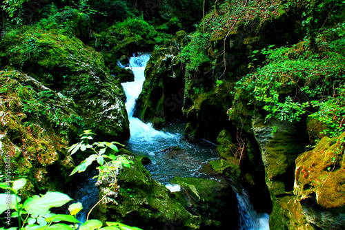 Charming view at the foaming waters of the Potenza river flowing near Sentiero Li Vurgacci in Pioraco, its rocky shores built inside the Sibillini Mountains' gorge, enclosing the stream from within photo