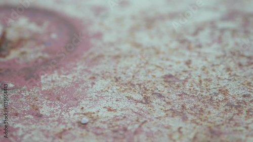 Forged iron ring on the cover of an old sewer iron manhole at an abandoned military base. Peeling old paint in several layers. Antique metalwork. Pula, Croatia - December 1, 2024