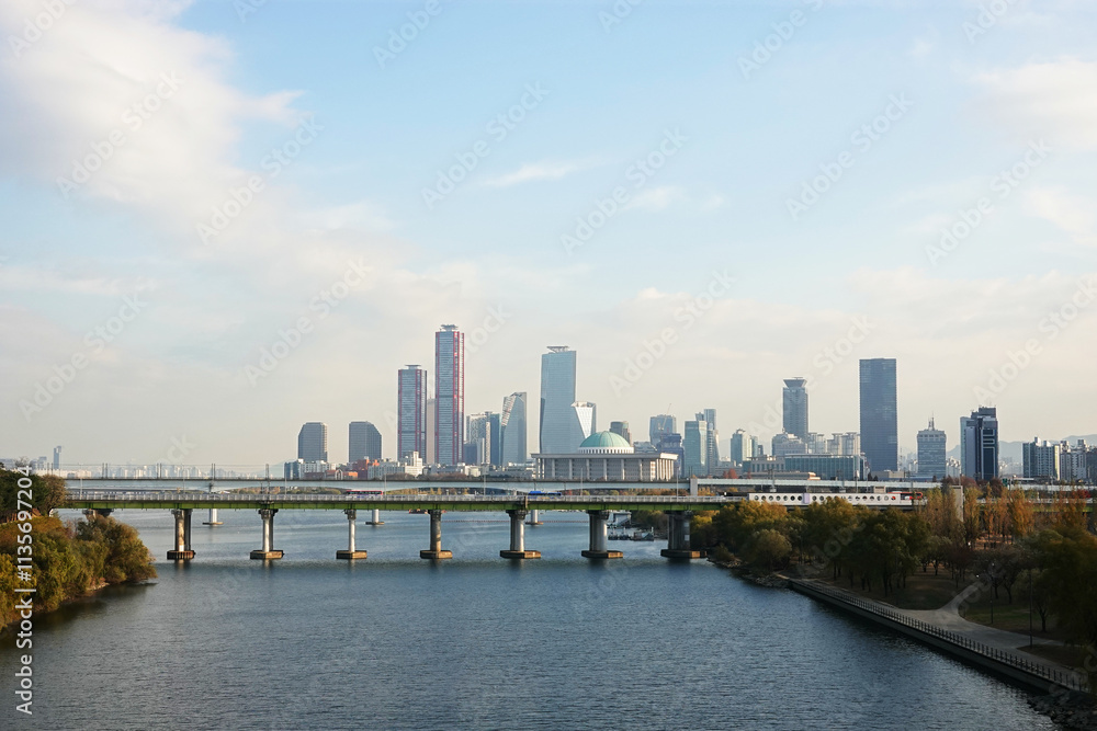 Fototapeta premium A skyline of Yeouido, Seoul, Korea with modern skyscrapers and a bridge over a river.