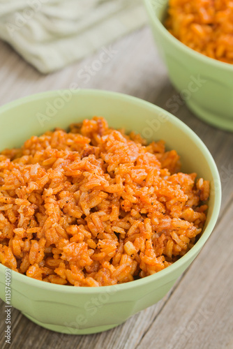 Homemade Mexican red rice or Arroz rojo made with onion, garlic and tomato or tomato paste or sauce, a traditional Mexican side dish (Selective Focus, Focus in the middle of the image)
