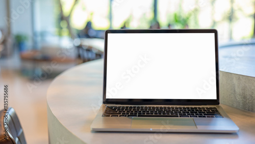 Workspace background new project on laptop computer with blank copy space screen for your advertising text message. Laptop with blank screen and placed on a wooden table inside a coffee shop.