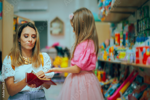Photos Mother Giving Pocket Money to her Little Girl in a Store