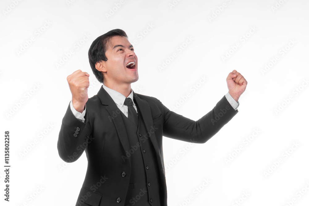 Excited and joyful young businessman wearing a formal black suit and tie, raising his fists in celebration of success and achievement, showing happiness and triumph, isolated on a white background Excited and joyful young businessman wearing a formal black suit and tie, raising his fists in celebration of success and achievement, showing happiness and triumph, isolated on a white background