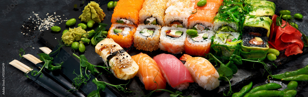 Sushi and roll set on dark background. Traditional food concept. Sushi and roll set on dark background. Traditional food concept.