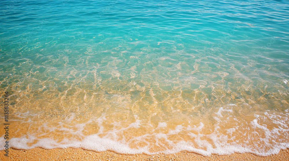 Crystal clear turquoise waves gently lap against a sandy shore on a sunny day Crystal clear turquoise waves gently lap against a sandy shore on a sunny day