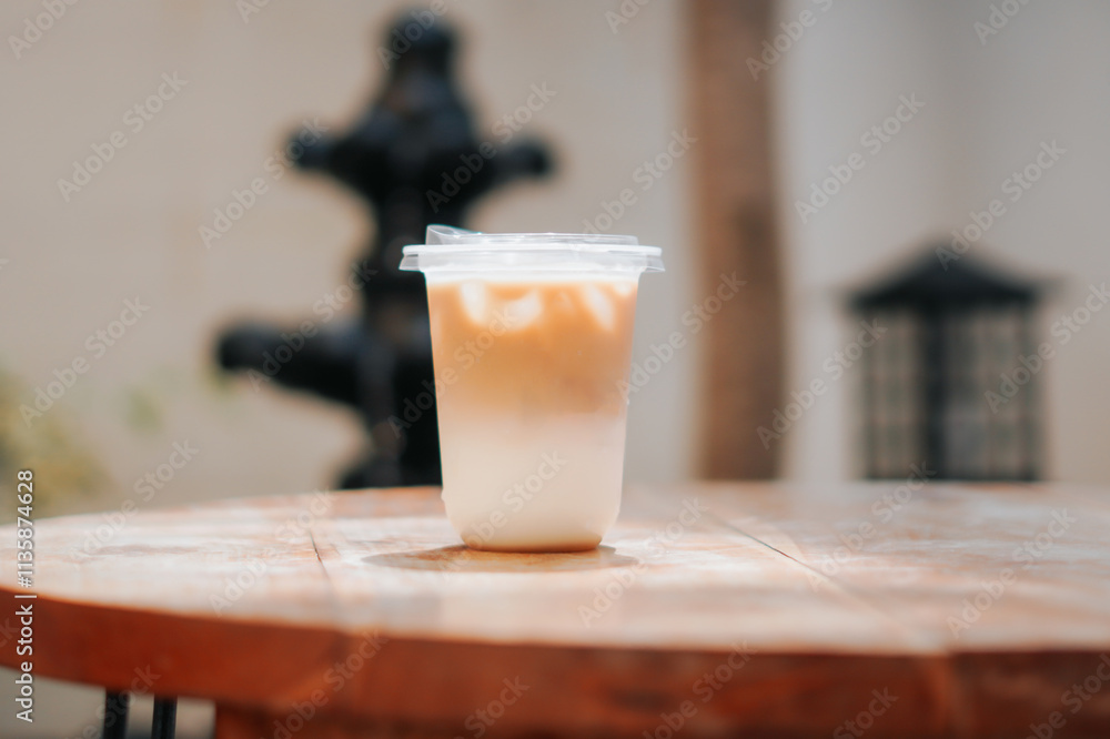 A refreshing glass of iced coffee sits on a wooden table, perfect for a sunny day. The image captures the drink's cool, refreshing appeal, perfect for cafes, food blogs, and lifestyle content. A refreshing glass of iced coffee sits on a wooden table, perfect for a sunny day. The image captures the drink's cool, refreshing appeal, perfect for cafes, food blogs, and lifestyle content.