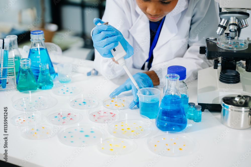 Young scientists conducting research investigations in a medical laboratory, a researcher in the foreground Young scientists conducting research investigations in a medical laboratory, a researcher in the foreground