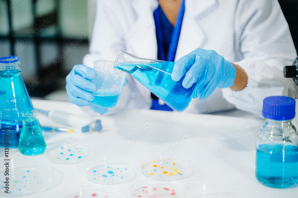 Young scientists conducting research investigations in a medical laboratory, a researcher in the foreground Young scientists conducting research investigations in a medical laboratory, a researcher in the foreground