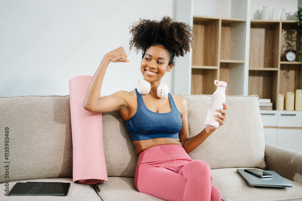 Active woman in athleisure sitting on yoga mat with tablet, headphones and modern home lifestyle. Active woman in athleisure sitting on yoga mat with tablet, headphones and modern home lifestyle.