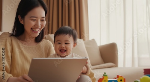 A joyful mother and her baby engage with a tablet, surrounded by toys in a cozy, sunlit living room.