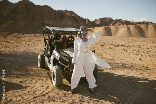 Woman tourist on quad bike ATV safari with desert background of Sharm El Sheikh Egypt