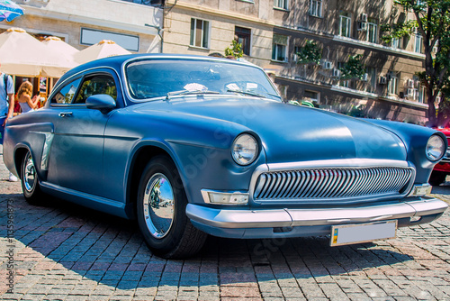 Beautiful tuned matte blue car in the summer on the square	
 photo