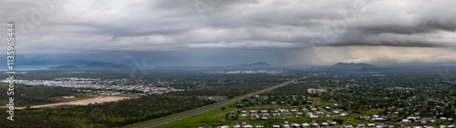 Storms over a mountain range and city in the distance, Townsville photo