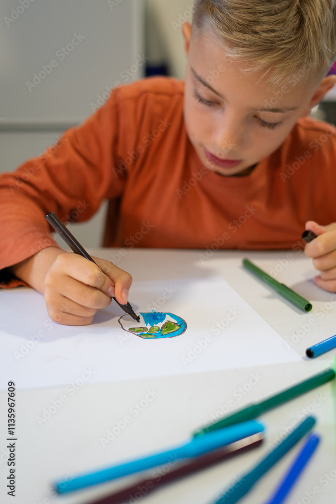 Child drawing planet earth with markers at home or school Child drawing planet earth with markers at home or school