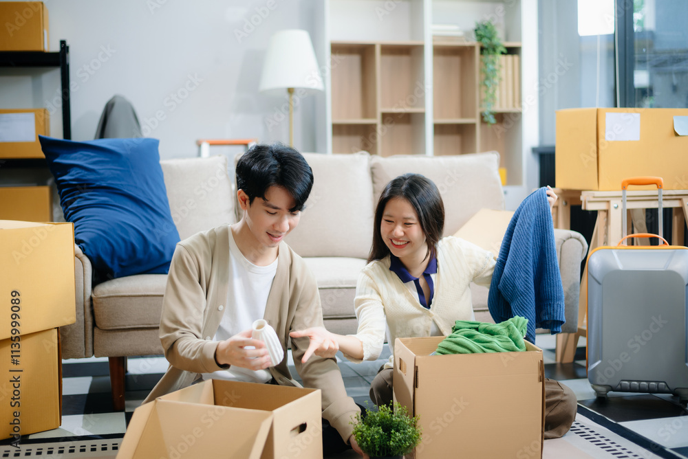 Young couple organizing belongings in a cozy home with boxes and luggage. Perfect for themes of moving Young couple organizing belongings in a cozy home with boxes and luggage. Perfect for themes of moving