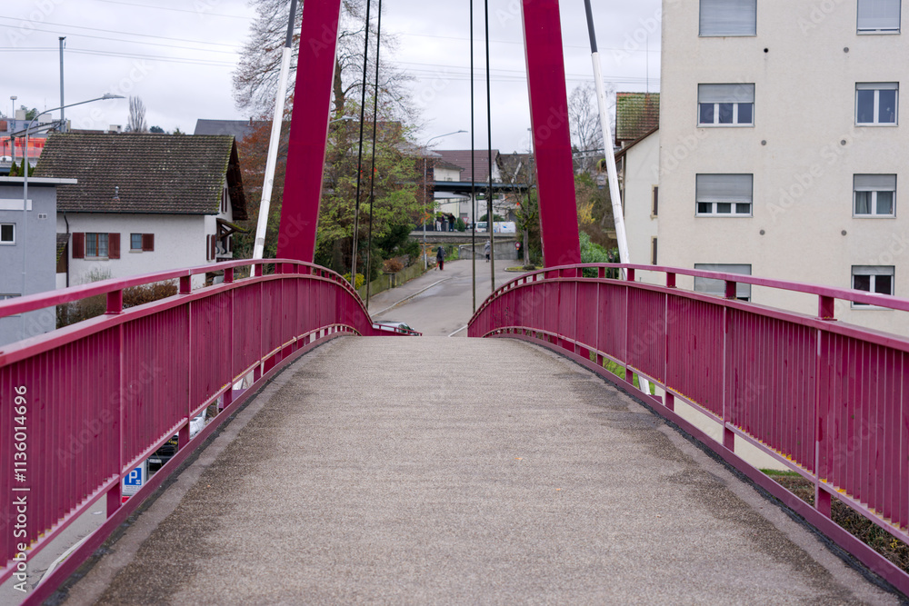 Obraz premium Close-up of red metal suspension footbridge village of Rümlang on an autumn day. Photo taken December 8th, 2024, Zurich Rümlang, Switzerland.