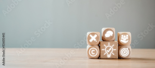 Wooden blocks with business icons representing corporate identity on a minimalist background, symbolizing innovation and strategy. photo