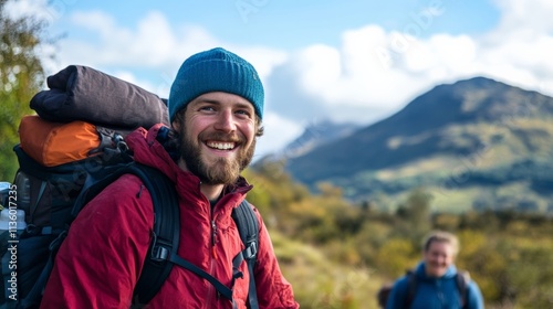 Smiling hiker with a backpack enjoys nature in the mountains on a sunny day. Adventure awaits in the great outdoors. Explore more!