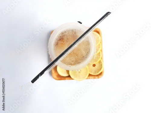 iced lemon tea packaged in a plastic cup on a white background