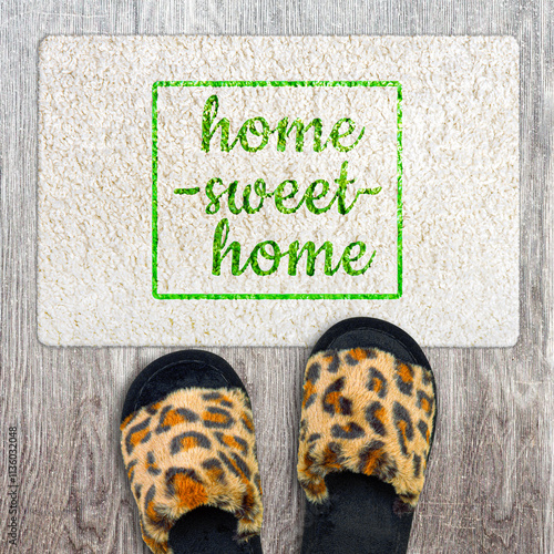 Home sweet home, inscription on the white doormat. Close-up. Backgrounds.