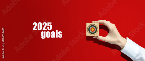 2025, Goals. Motivational poster with a goal in a woman's hand, on a red background. Goals and plans for the next year. Business. Lifestyle. Motivation.