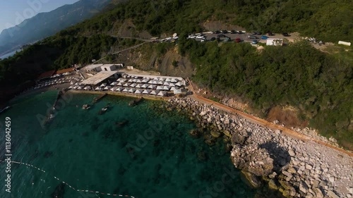 Aerial fpv racing drone flying over sea waters along Galija coast in Budva region of Montenegro