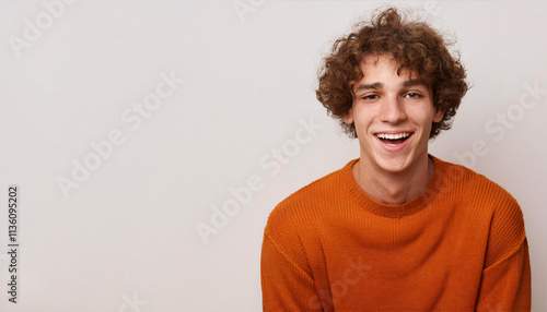 Wallpaper Mural Laughter and happiness shine through in the expression of the young man wearing an orange sweater Torontodigital.ca