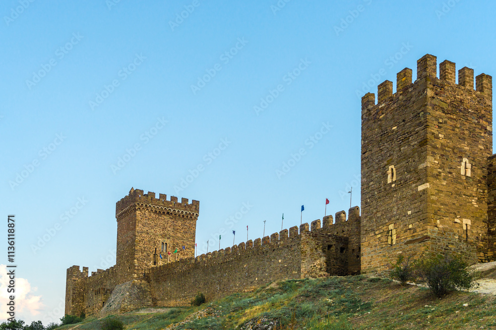 Beautiful view of the fortress wall with towers of the Genoese fortress in the city of Sudak. Crimean Peninsula. Russia Beautiful view of the fortress wall with towers of the Genoese fortress in the city of Sudak. Crimean Peninsula. Russia